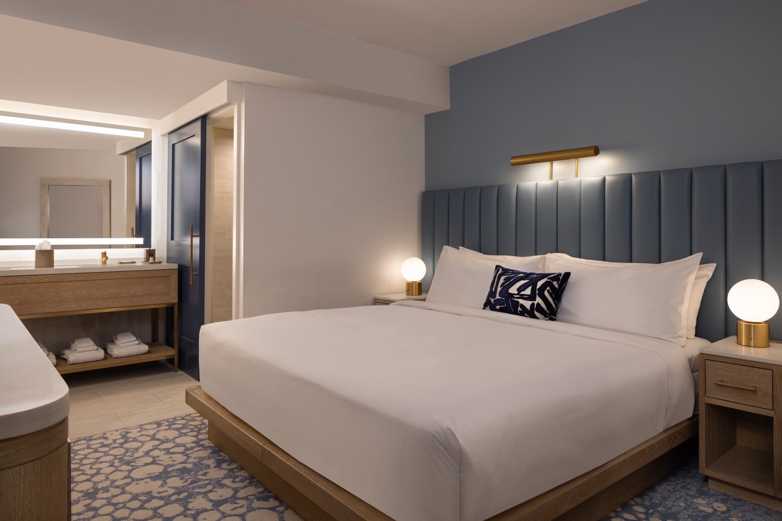 King sized Bed in room with large blue headboard