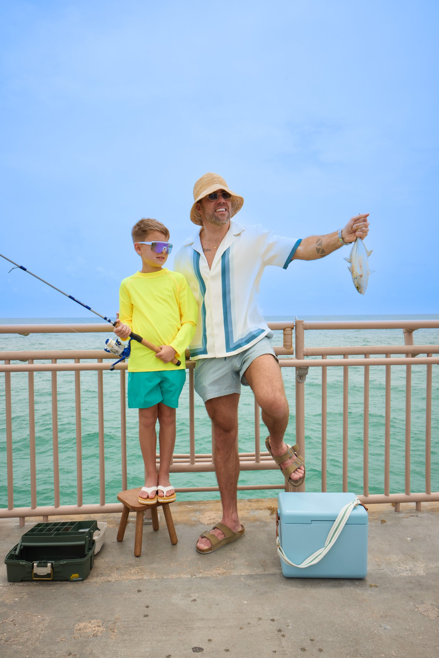 A dad and a kid fishing on Newport Fishing Pier