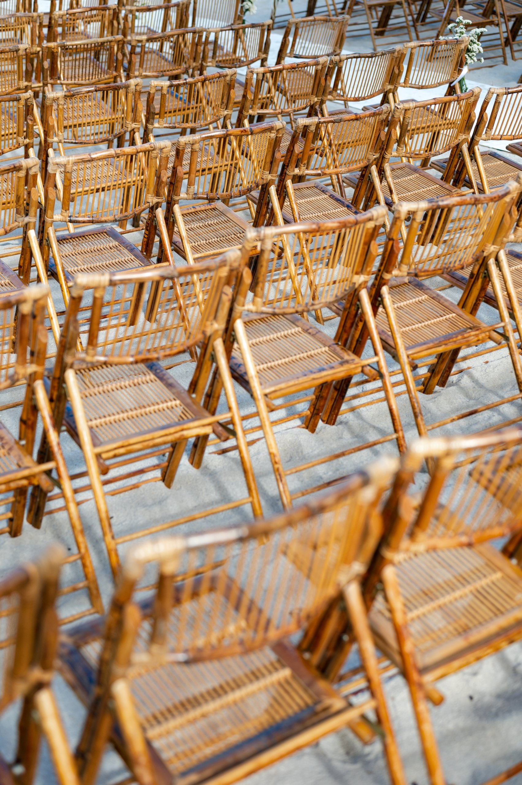 Wooden chairs on sand for event settings