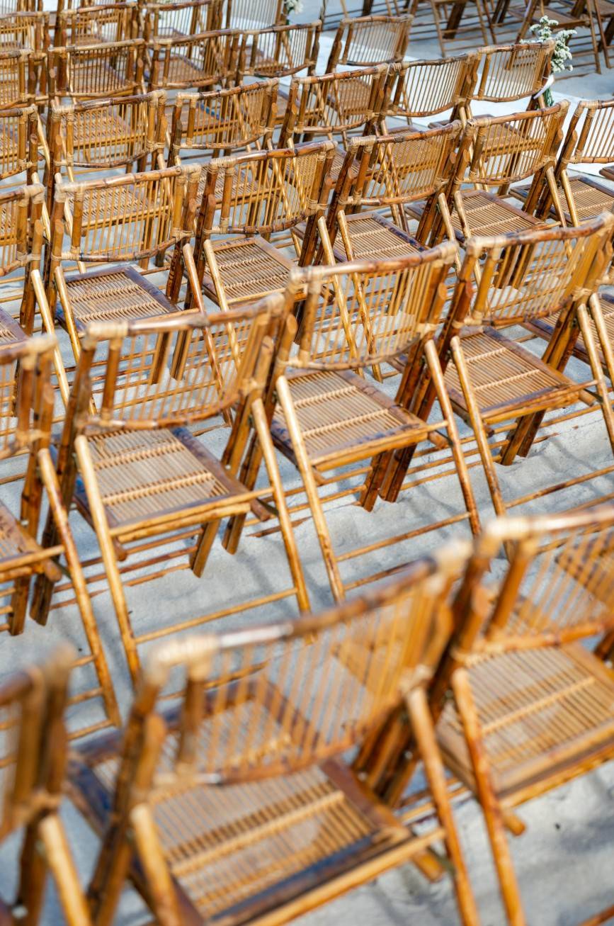 Wooden chairs on sand for event settings