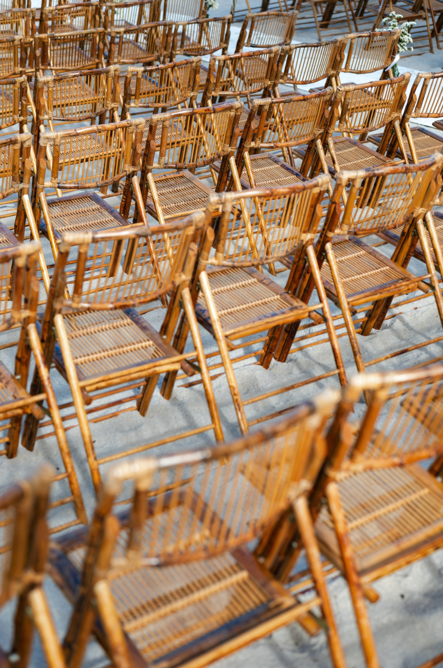 Wooden chairs on sand for event settings