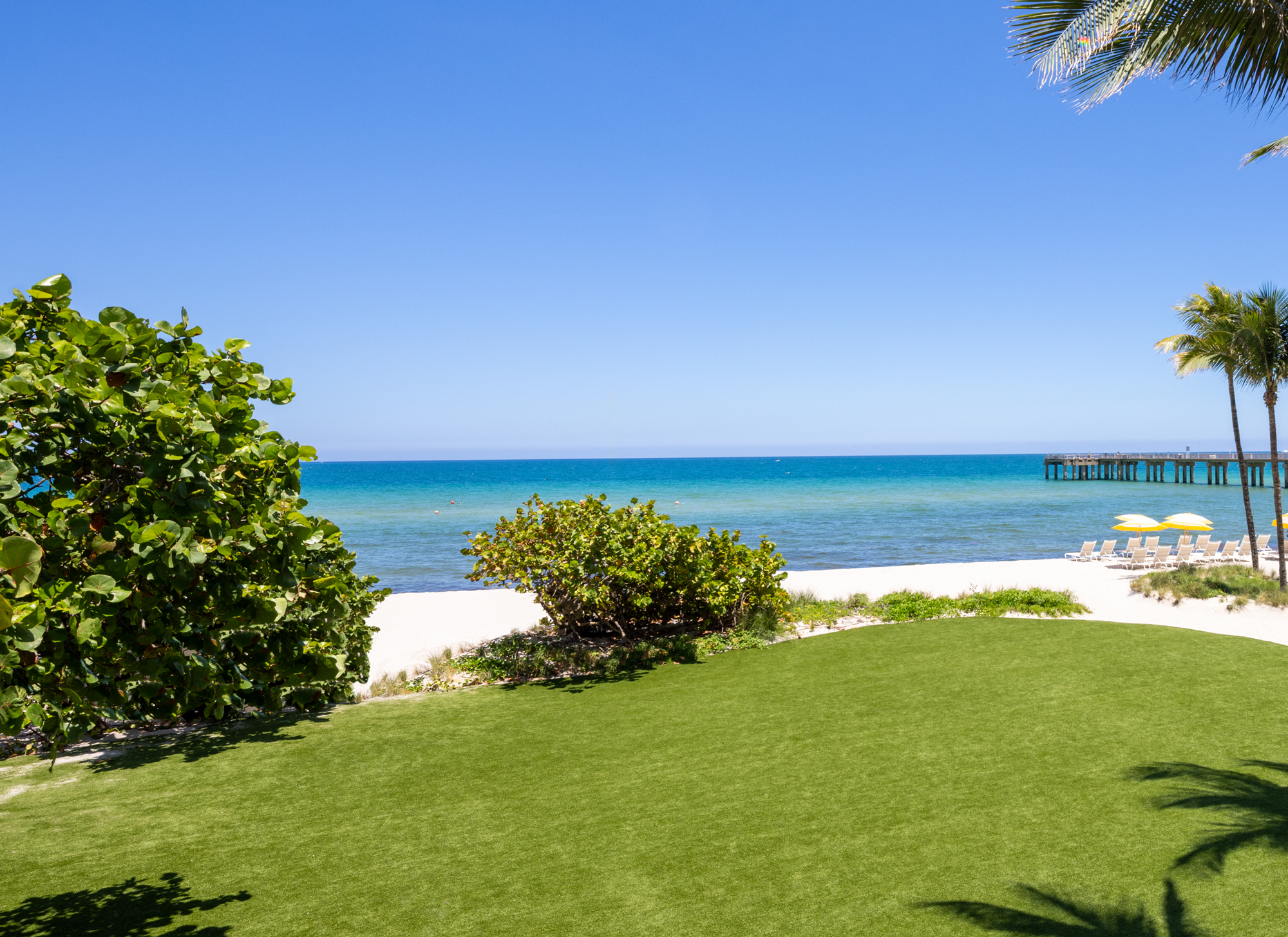Landscape image overlooking a green lawn to see the beach